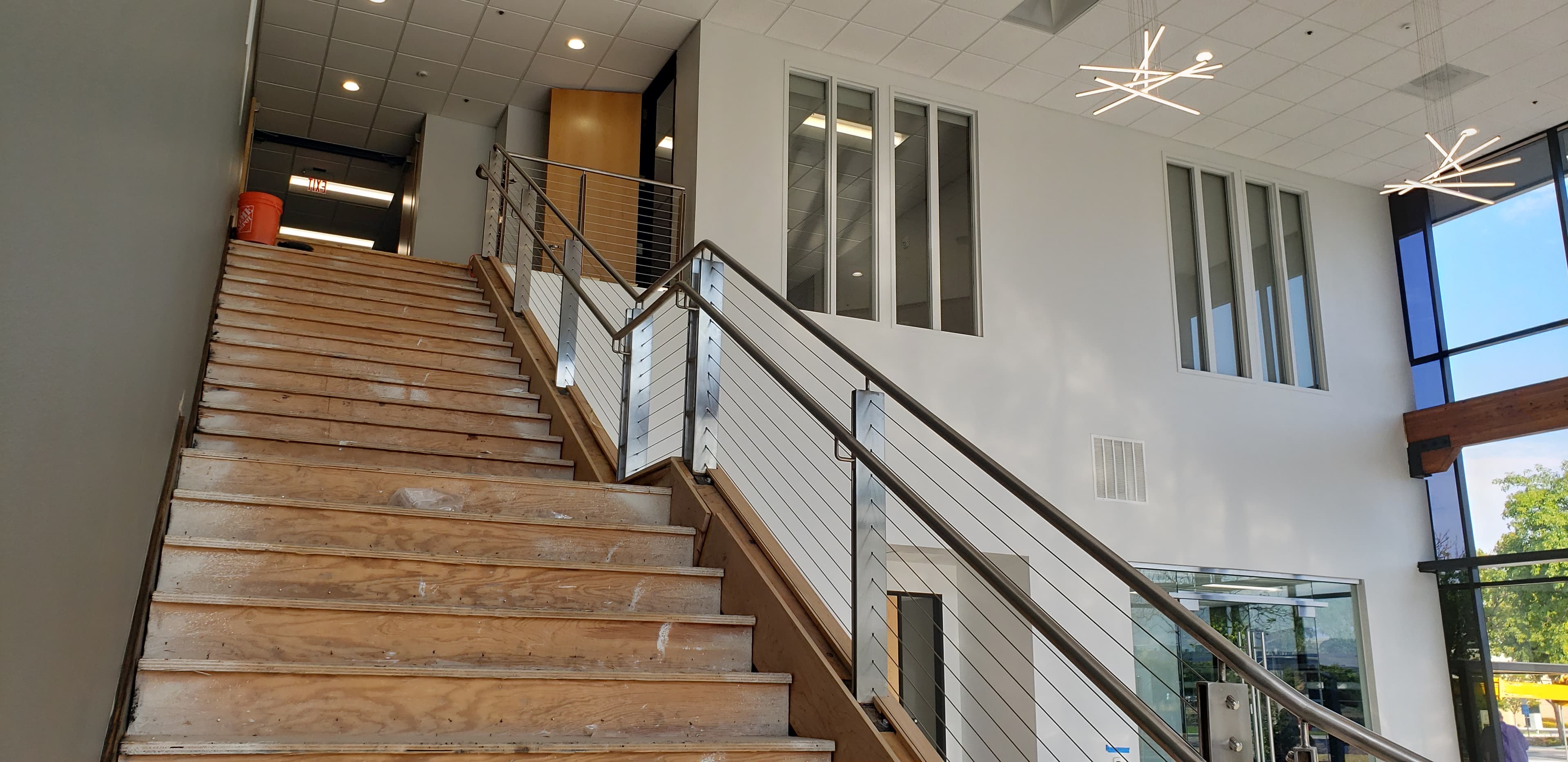 288 SOUTH SUNNYVALE — Feature lobby stair with steel stringers, stainless handrails, and cable guardrails.